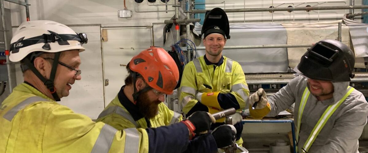 Pipe Fabrication: smiling installers assembling a pipeline